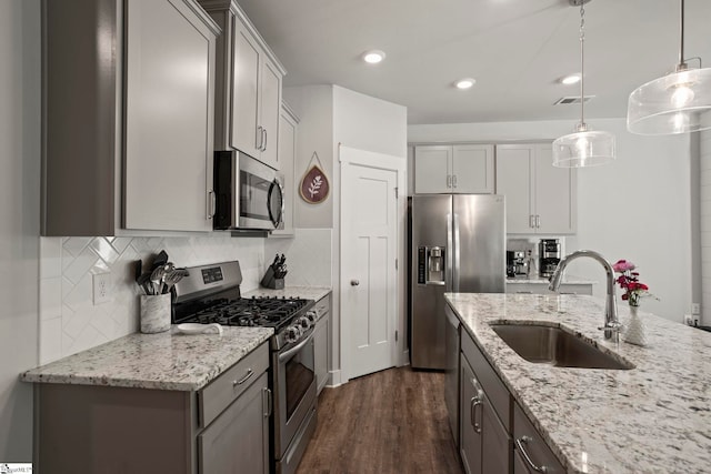 7 Grey Oak Trl, Greer, SC 29650 - kitchen featuring appliances with stainless steel finishes, a sink, dark wood-style flooring, decorative backsplash, and pendant lighting