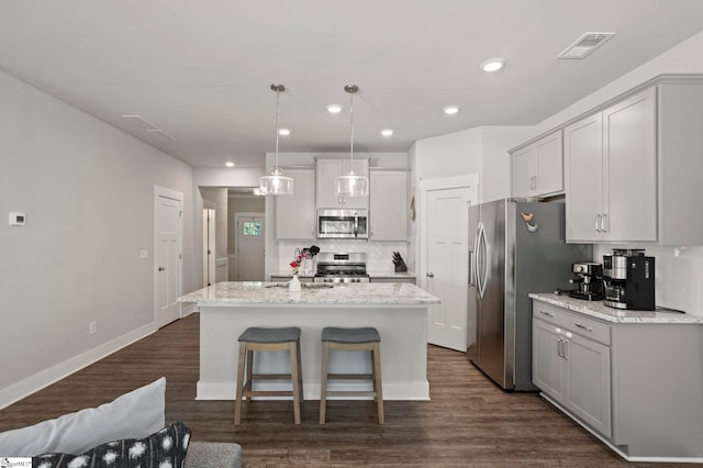 7 Grey Oak Trl, Greer, SC 29650 - kitchen featuring appliances with stainless steel finishes, backsplash, a center island with sink, recessed lighting, and dark wood-style floors