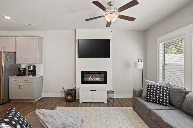 7 Grey Oak Trl, Greer, SC 29650 - living room featuring dark wood-style flooring, baseboards, a ceiling fan, and a glass covered fireplace