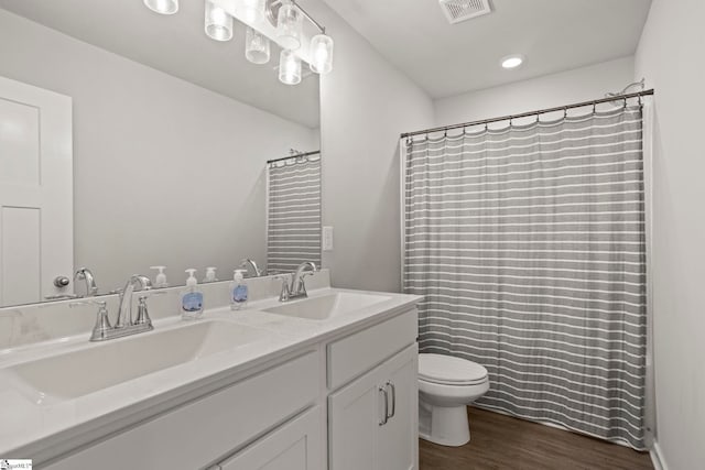 7 Grey Oak Trl, Greer, SC 29650 - full bathroom featuring toilet, double vanity, wood finished floors, and a shower with shower curtain