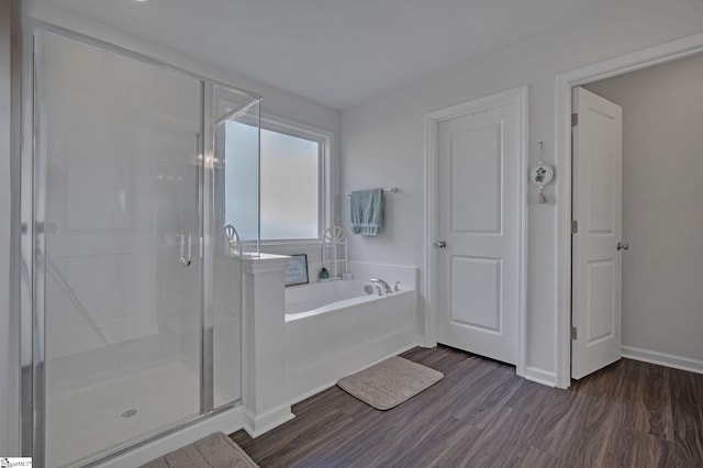 105 Ella B Ln, Easley, SC 29640 - bathroom with a bath, a stall shower, wood finished floors, and baseboards