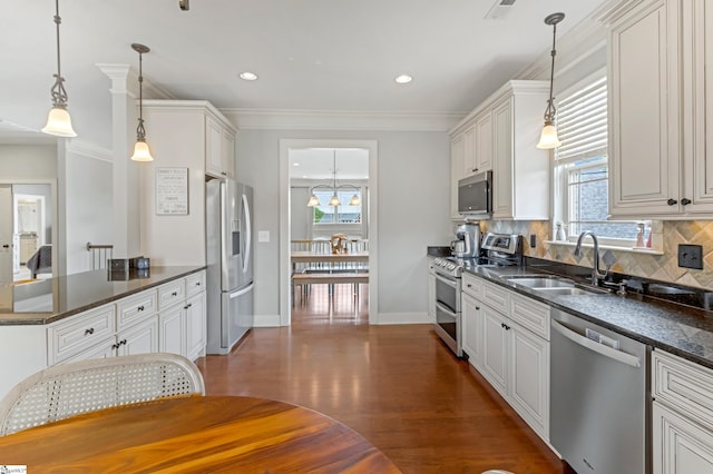 10 Croydon Way, Greenville, SC 29609 - kitchen with appliances with stainless steel finishes, a sink, plenty of natural light, decorative backsplash, and crown molding