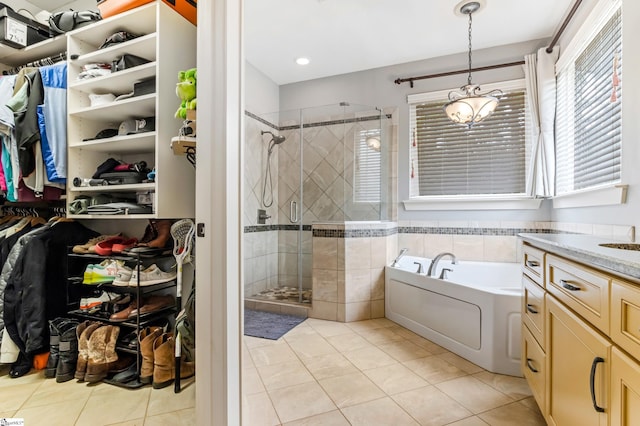10 Croydon Way, Greenville, SC 29609 - bathroom featuring a garden tub, a stall shower, a spacious closet, and tile patterned floors