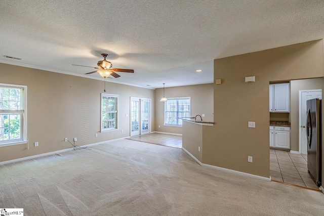 122 N Orchard Farms Ave, Simpsonville, SC 29681 - spare room with a ceiling fan, a textured ceiling, baseboards, light colored carpet, and crown molding