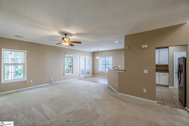 122 N Orchard Farms Ave, Simpsonville, SC 29681 - spare room with ceiling fan, light colored carpet, baseboards, a textured ceiling, and crown molding