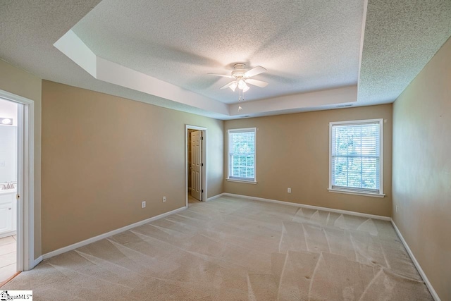 122 N Orchard Farms Ave, Simpsonville, SC 29681 - empty room featuring a textured ceiling, plenty of natural light, a raised ceiling, a ceiling fan, and light carpet