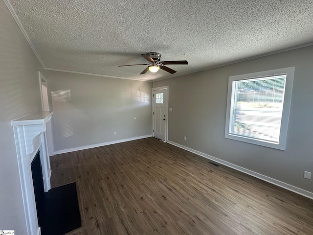 121 Pacolet Hwy, Gaffney, SC 29340 - unfurnished living room featuring ceiling fan, dark wood-style floors, plenty of natural light, a textured ceiling, and a fireplace