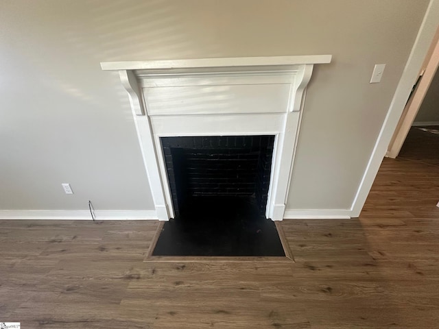 121 Pacolet Hwy, Gaffney, SC 29340 - detailed view of a fireplace with flush hearth, baseboards, and wood finished floors