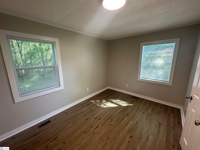 121 Pacolet Hwy, Gaffney, SC 29340 - unfurnished room featuring plenty of natural light, baseboards, a textured ceiling, dark wood finished floors, and ornamental molding