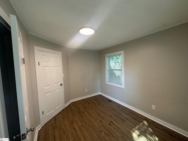 121 Pacolet Hwy, Gaffney, SC 29340 - spare room featuring dark wood-style floors, baseboards, crown molding, and a textured ceiling