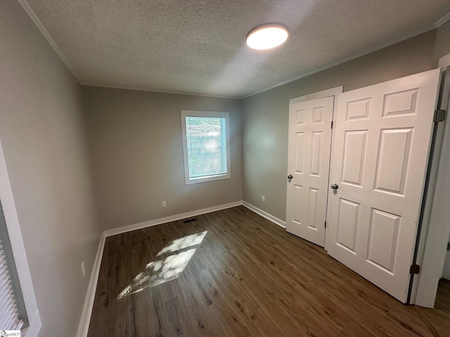 121 Pacolet Hwy, Gaffney, SC 29340 - unfurnished bedroom with a textured ceiling, dark wood-style flooring, baseboards, and ornamental molding