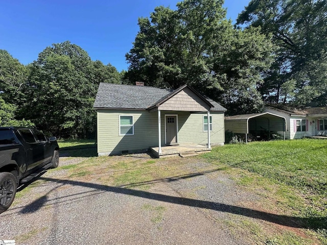 121 Pacolet Hwy, Gaffney, SC 29340 - bungalow-style house with a front lawn, a chimney, crawl space, a shingled roof, and a carport