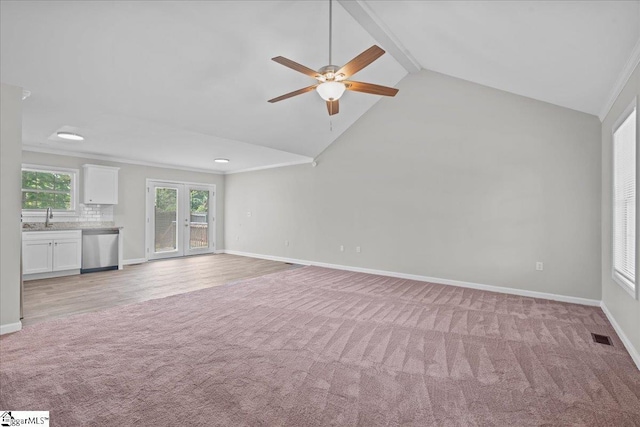 514 Habersham Ln, Easley, SC 29642 - unfurnished living room with light colored carpet, ceiling fan, baseboards, a sink, and ornamental molding