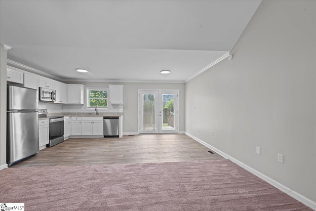 514 Habersham Ln, Easley, SC 29642 - kitchen featuring appliances with stainless steel finishes, crown molding, baseboards, a sink, and white cabinets