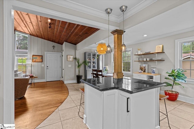 116 Twinbrook Dr, Greenville, SC 29607 - kitchen featuring a kitchen breakfast bar, light tile patterned floors, lofted ceiling, baseboards, and ornamental molding