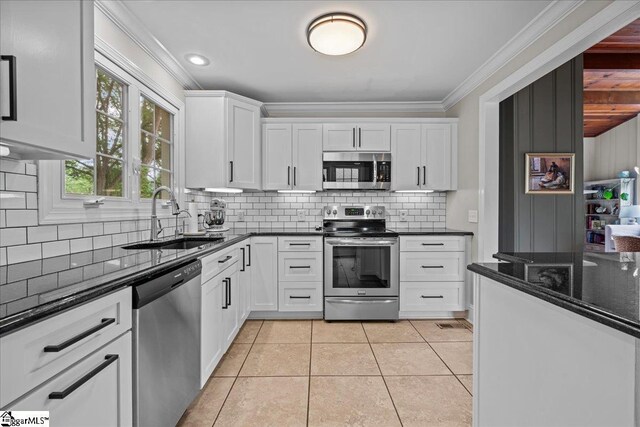 116 Twinbrook Dr, Greenville, SC 29607 - kitchen with stainless steel appliances, a sink, white cabinets, backsplash, and crown molding