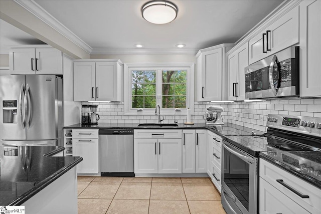 116 Twinbrook Dr, Greenville, SC 29607 - kitchen featuring stainless steel appliances, a sink, crown molding, light tile patterned floors, and white cabinets