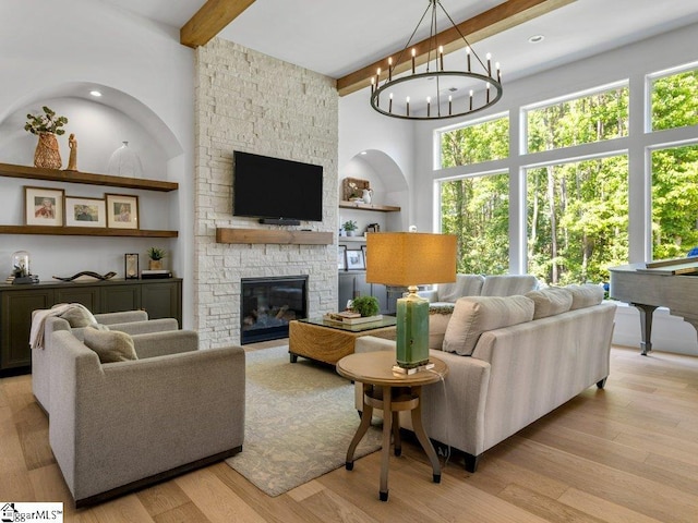 294 Lyman Lake Rd, Lyman, SC 29365 - living area featuring beamed ceiling, plenty of natural light, a stone fireplace, a high ceiling, and light wood finished floors