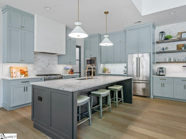 294 Lyman Lake Rd, Lyman, SC 29365 - kitchen featuring appliances with stainless steel finishes, tasteful backsplash, a kitchen bar, a kitchen island with sink, and recessed lighting
