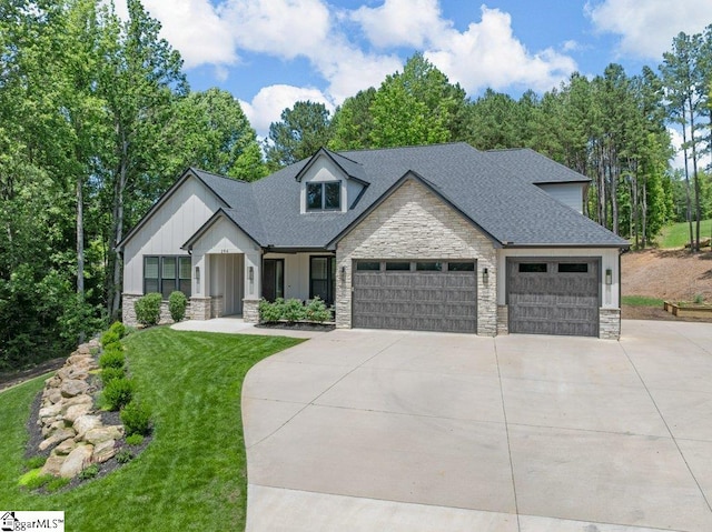 294 Lyman Lake Rd, Lyman, SC 29365 - view of front of home with stone siding, driveway, an attached garage, roof with shingles, and a front yard