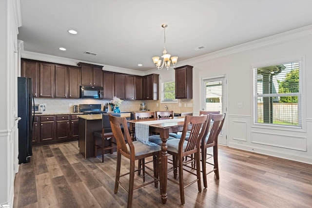 412 Kindletree Way, Simpsonville, SC 29680 - dining space featuring a chandelier, dark wood-style flooring, crown molding, and recessed lighting
