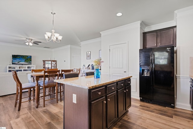 412 Kindletree Way, Simpsonville, SC 29680 - kitchen with black fridge, ceiling fan, a chandelier, wood finished floors, and ornamental molding
