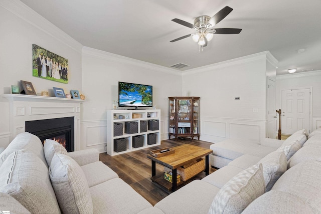 412 Kindletree Way, Simpsonville, SC 29680 - living area featuring ornamental molding, a ceiling fan, a glass covered fireplace, wood finished floors, and a decorative wall