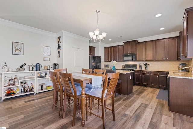 412 Kindletree Way, Simpsonville, SC 29680 - dining area featuring ornamental molding, a chandelier, wood finished floors, and recessed lighting