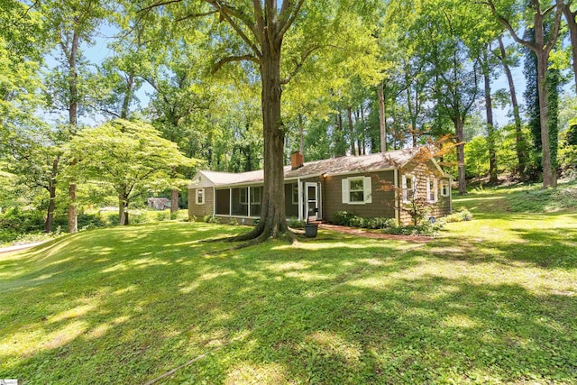 100 Maxwell Rd, Spartanburg, SC 29302 - view of front facade featuring a chimney, a front lawn, and view of wooded area