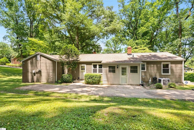 100 Maxwell Rd, Spartanburg, SC 29302 - back of property featuring a yard, a chimney, central AC unit, and a patio