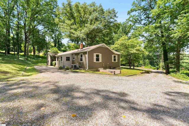 100 Maxwell Rd, Spartanburg, SC 29302 - view of side of property with a chimney, driveway, cooling unit, and view of scattered trees