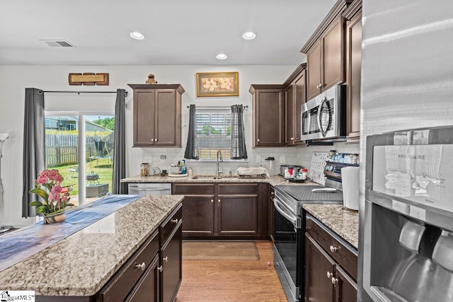 559 Falls Cottage Run, Boiling Springs, SC 29316 - kitchen featuring stainless steel appliances, dark brown cabinetry, plenty of natural light, decorative backsplash, and recessed lighting