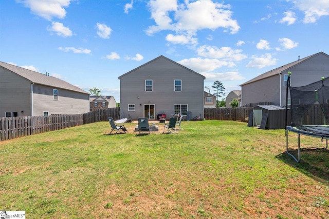 559 Falls Cottage Run, Boiling Springs, SC 29316 - rear view of property with a trampoline, an outdoor fire pit, and a patio area