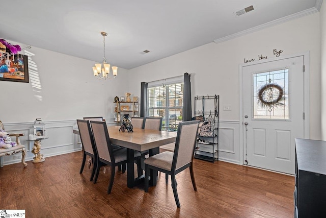 559 Falls Cottage Run, Boiling Springs, SC 29316 - dining space with a chandelier, dark wood-style floors, a decorative wall, wainscoting, and ornamental molding