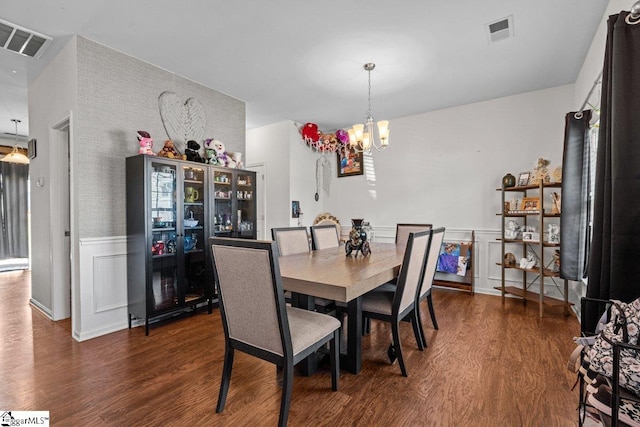 559 Falls Cottage Run, Boiling Springs, SC 29316 - dining space with wood finished floors, a chandelier, and a wainscoted wall