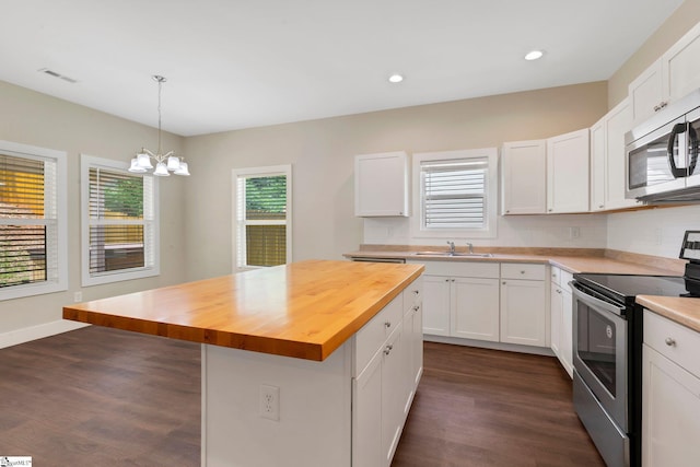 184 Sandifer Rd, Spartanburg, SC 29303 - kitchen featuring appliances with stainless steel finishes, butcher block counters, a sink, dark wood-style floors, and recessed lighting