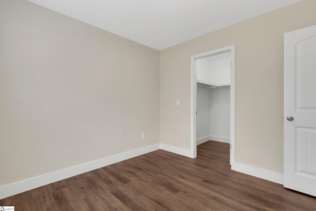 184 Sandifer Rd, Spartanburg, SC 29303 - unfurnished bedroom with dark wood-type flooring, baseboards, a spacious closet, and a closet