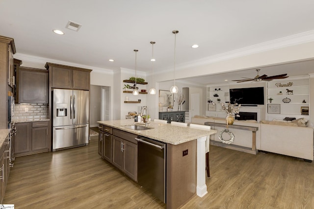 131 Riverland Woods Ct, Simpsonville, SC 29681 - kitchen featuring appliances with stainless steel finishes, a sink, dark wood-style floors, dark brown cabinets, and ornamental molding