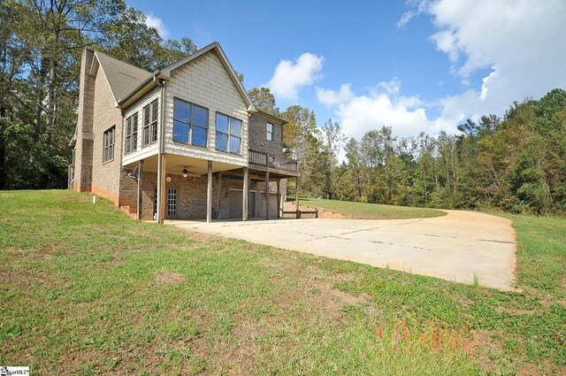 3973 S Harper Street Ext, Laurens, SC 29360 - rear view of property featuring concrete driveway, a lawn, an attached garage, and ceiling fan