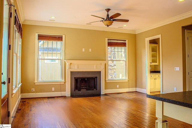 231 Austin Brook St, Simpsonville, SC 29680 - unfurnished living room featuring plenty of natural light, wood finished floors, a fireplace with flush hearth, crown molding, and recessed lighting