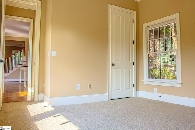 231 Austin Brook St, Simpsonville, SC 29680 - empty room featuring carpet, healthy amount of natural light, stairs, baseboards, and ornamental molding