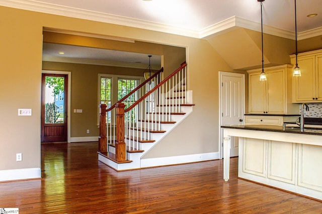 231 Austin Brook St, Simpsonville, SC 29680 - kitchen featuring dark wood-type flooring, a sink, dark countertops, baseboards, and crown molding