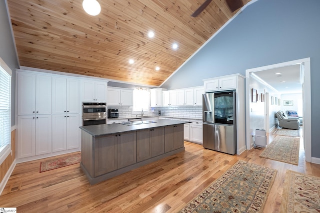 1122 Midway Rd, Pickens, SC 29671 - kitchen featuring stainless steel appliances, white cabinetry, backsplash, light wood-type flooring, and high vaulted ceiling