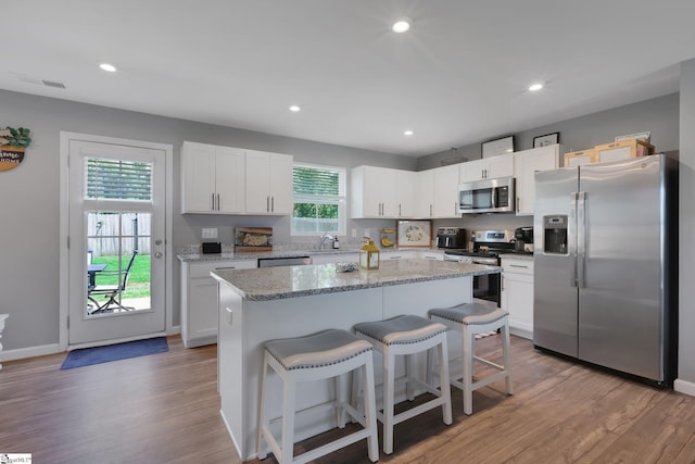 212 Ralston Dr, Greer, SC 29651 - kitchen with stainless steel appliances, light wood finished floors, a kitchen breakfast bar, a kitchen island, and recessed lighting