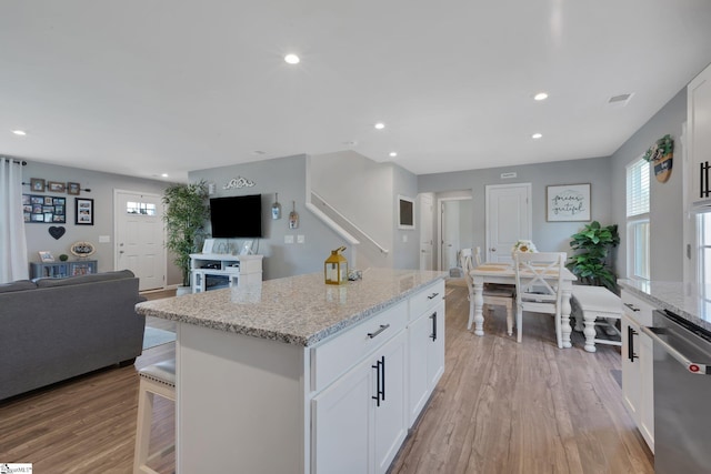 212 Ralston Dr, Greer, SC 29651 - kitchen featuring dishwasher, open floor plan, white cabinets, a center island, and light wood finished floors