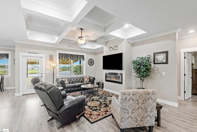 222 Blease Horton Rd, Boiling Springs, SC 29316 - living area featuring light wood-style floors, baseboards, beam ceiling, a glass covered fireplace, and crown molding