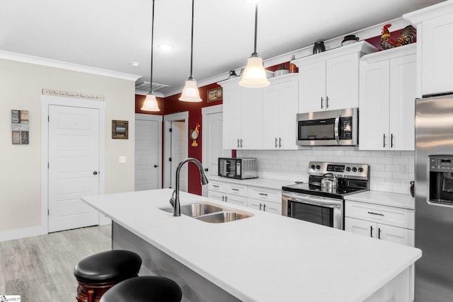 222 Blease Horton Rd, Boiling Springs, SC 29316 - kitchen featuring appliances with stainless steel finishes, a sink, a kitchen island with sink, crown molding, and decorative backsplash