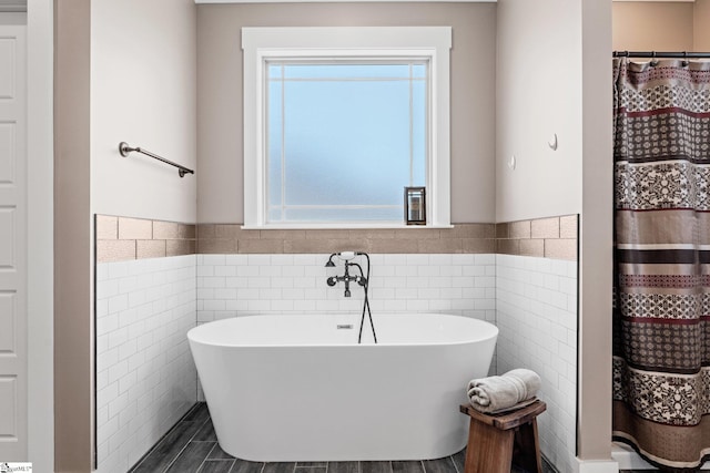 222 Blease Horton Rd, Boiling Springs, SC 29316 - bathroom featuring tile walls, wainscoting, and a soaking tub