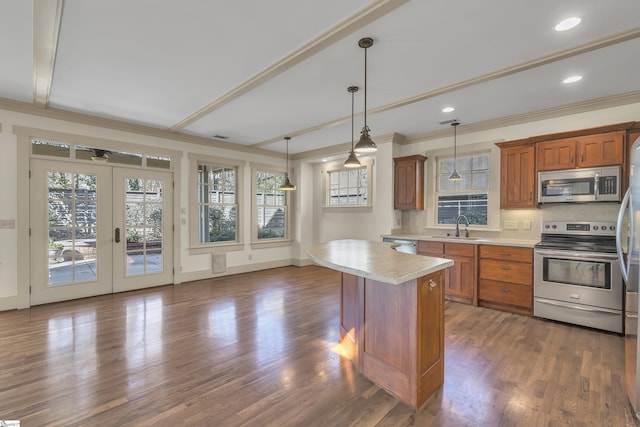 509B Townes St, Greenville, SC 29601 - kitchen featuring stainless steel appliances, a sink, crown molding, brown cabinets, and backsplash