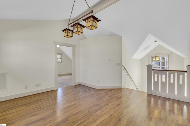 509B Townes St, Greenville, SC 29601 - unfurnished living room featuring vaulted ceiling, wood finished floors, and baseboards